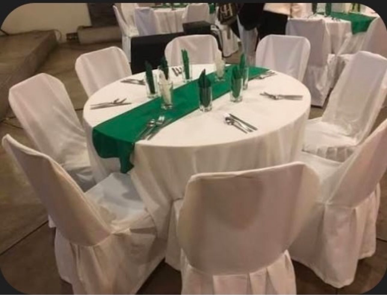 Round table with white cloth and covered chairs